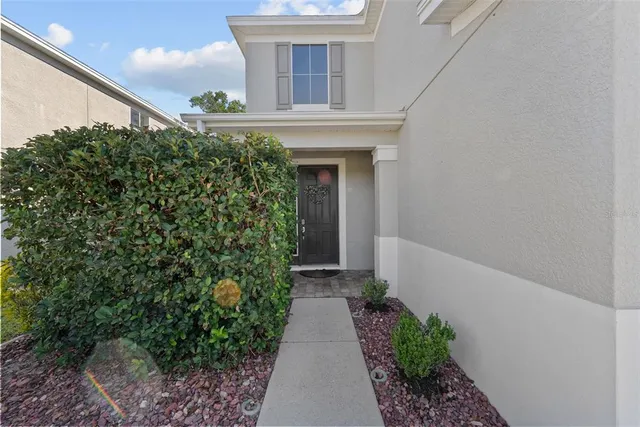 a living room with furniture and a large window with kitchen view