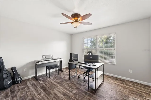 a view of a patio with table and chairs potted plants with large tree
