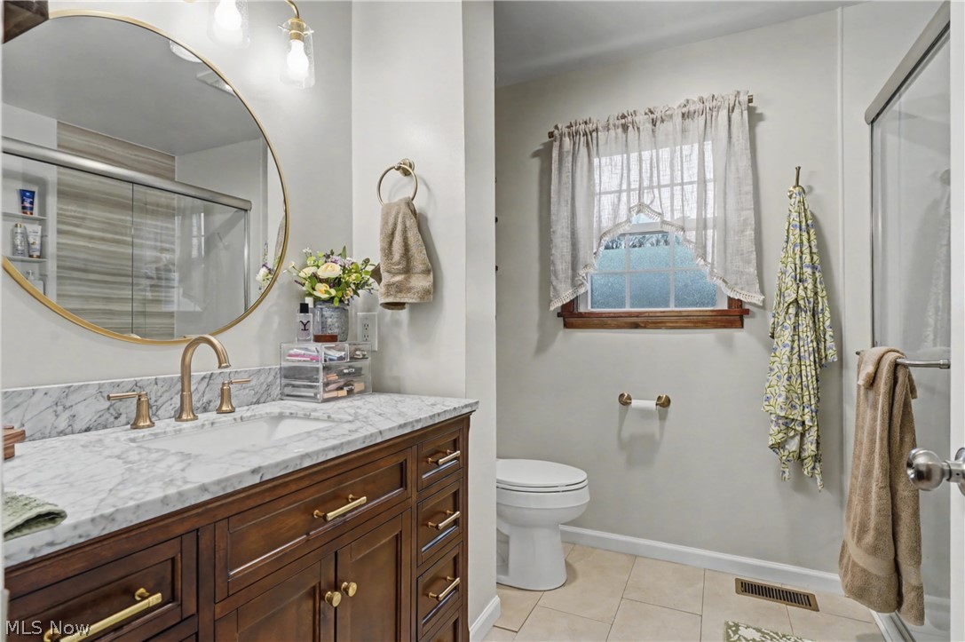 4556 Rootstown Road Ravenna, OH 44266 - Photo 19 of 50 Bathroom featuring vanity, a stall shower, and light tile patterned flooring