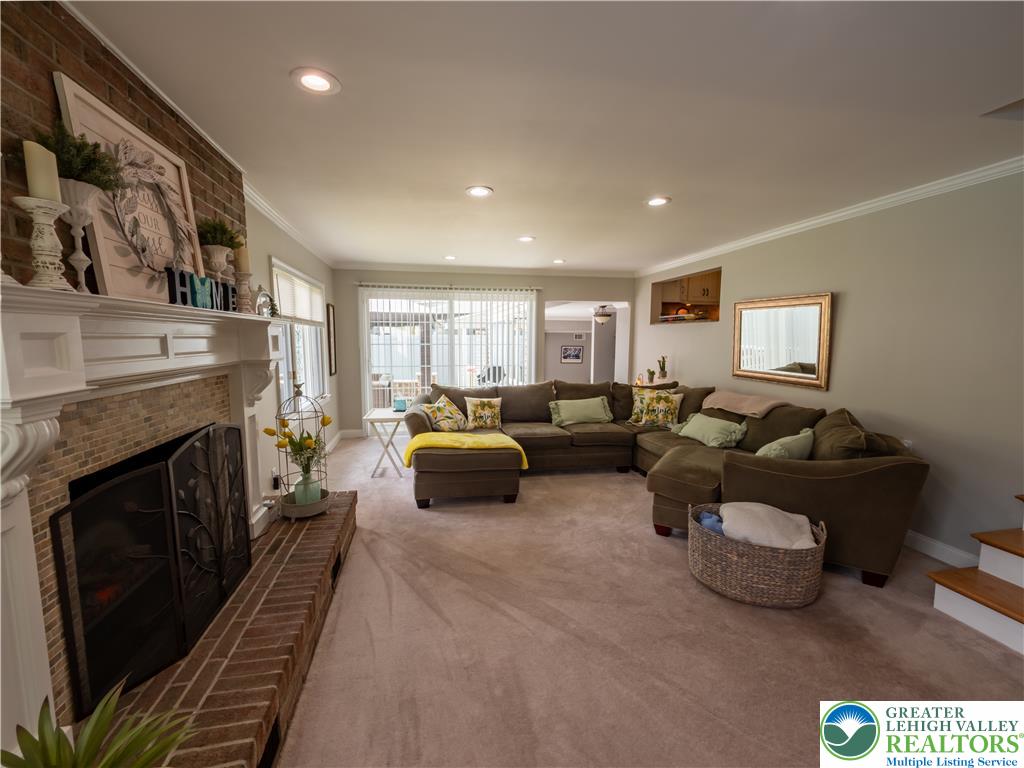 2087 Hopewell Road Bethlehem, PA 18017 - Photo 19 of 38 A comforting living area offers a brick fireplace with a detailed mantelpiece and generous natural illumination.