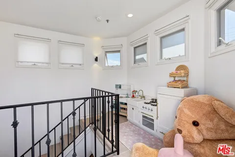 a bedroom with furniture and baby crib