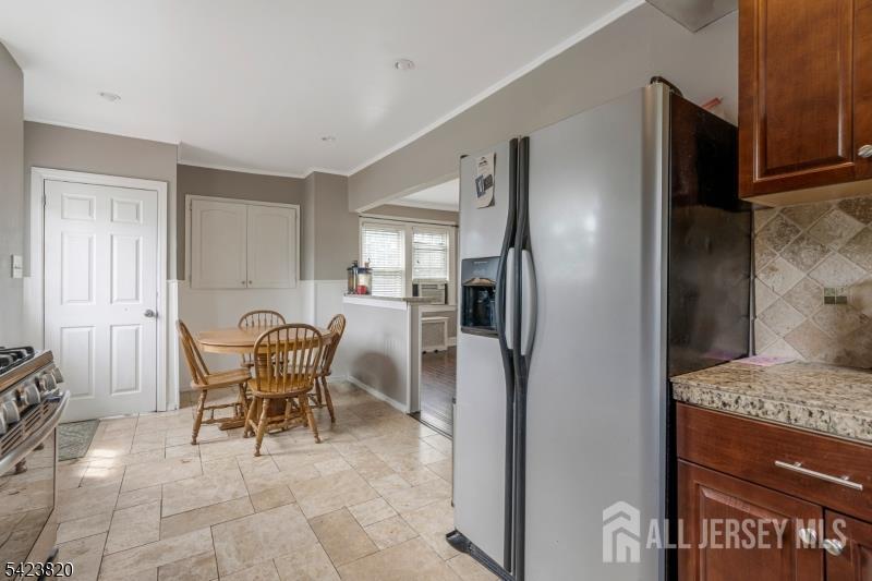 110 Parker Street Middlesex, NJ 08846 - Photo 12 of 25 a dining room with furniture and a refrigerator