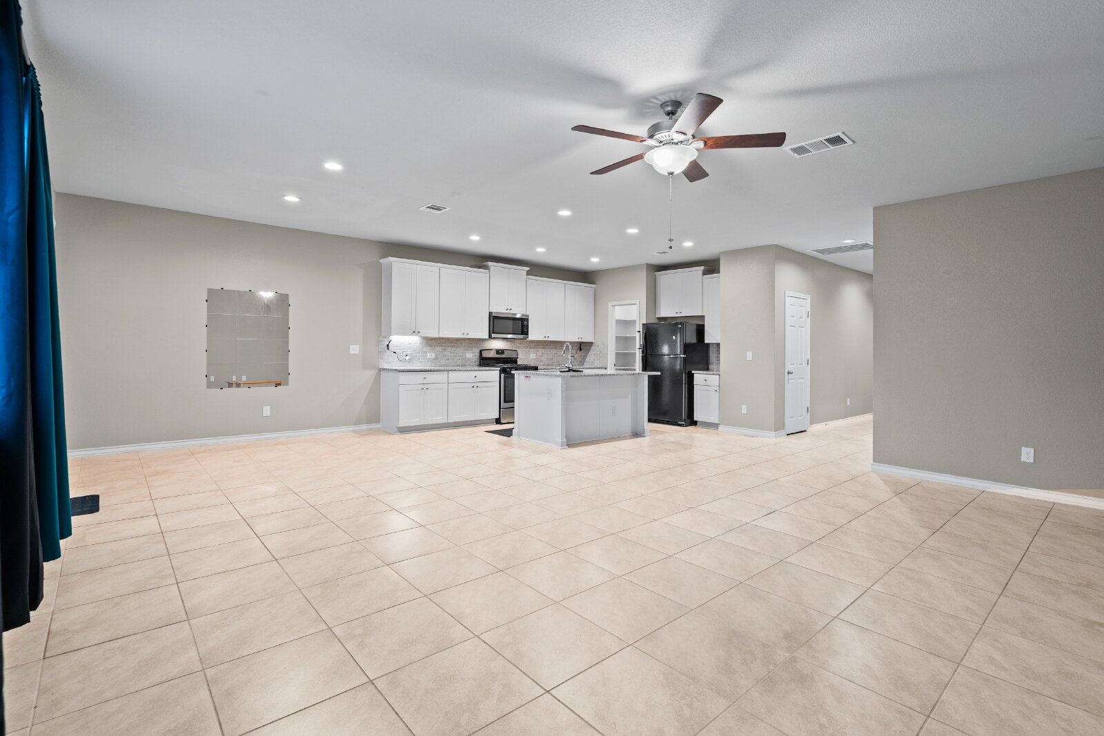 204 Tulum Terrace Leander, TX 78641 - Photo 21 of 22 Kitchen featuring open floor plan, ceiling fan, white cabinetry, stainless steel appliances, and recessed lighting