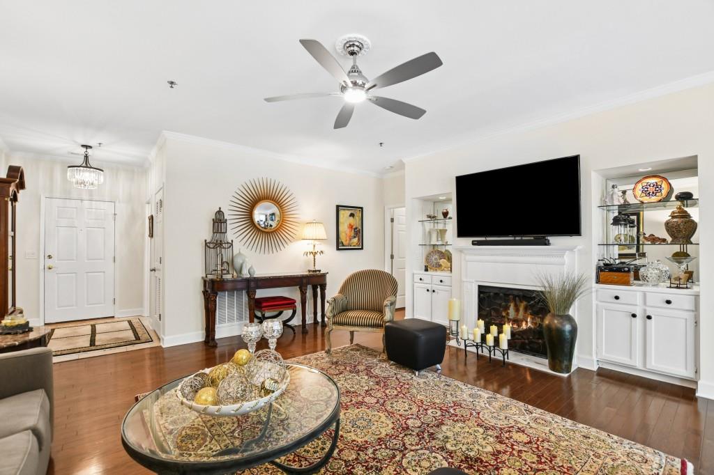 2921 Lenox Road Northeast, Unit 103 Atlanta, GA 30324 - Photo 4 of 37 a living room with furniture a fireplace and a flat screen tv