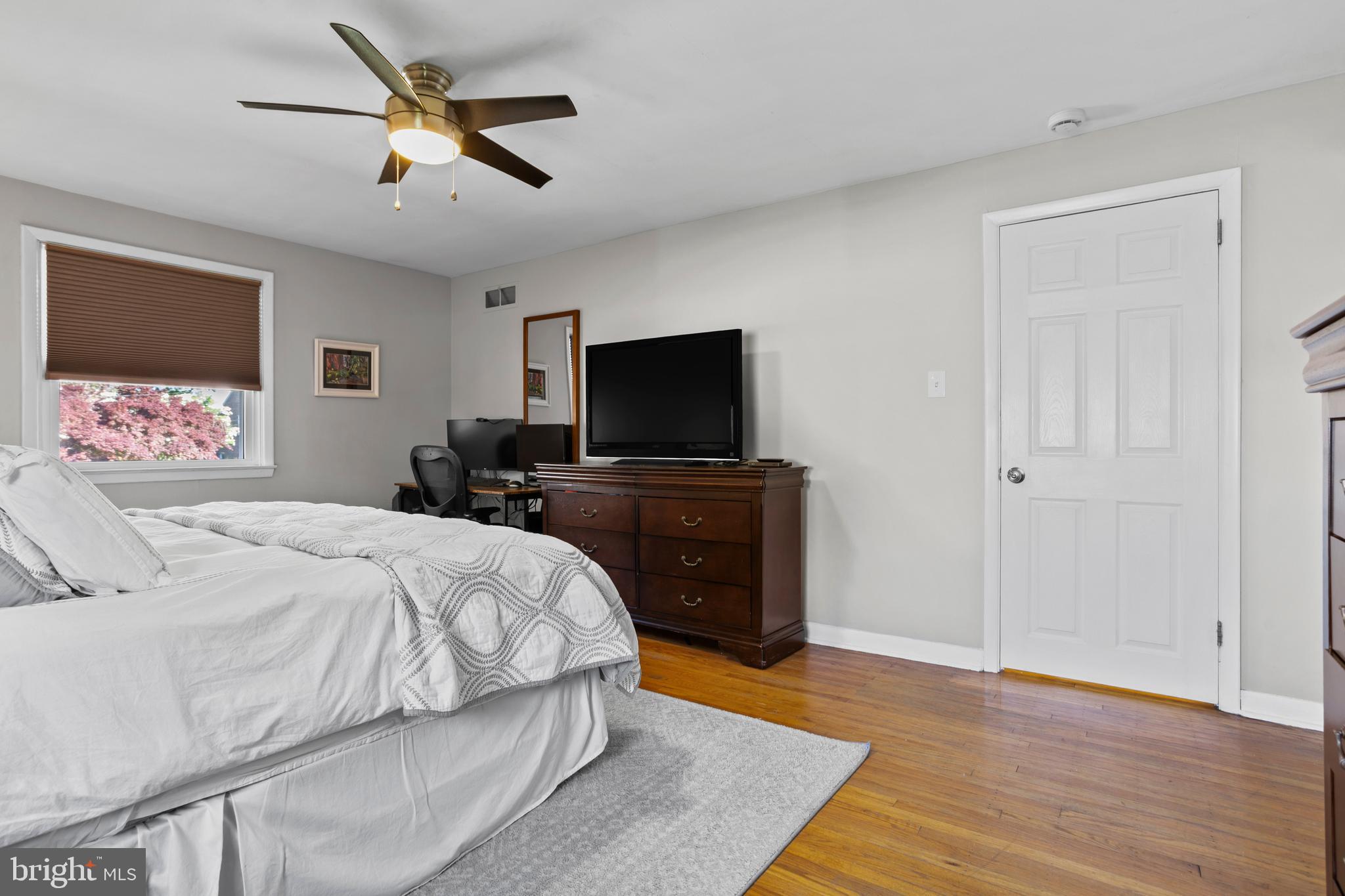 105 Longview Drive Springfield, PA 19064 - Photo 17 of 33 a bedroom with a bed a dresser and flat screen tv