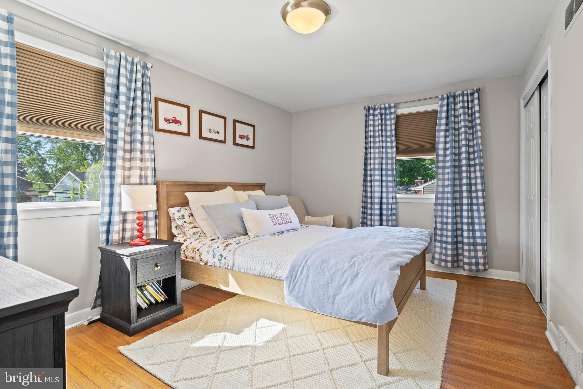 105 Longview Drive Springfield, PA 19064 - Photo 19 of 33 a bedroom with a bed and wooden floor