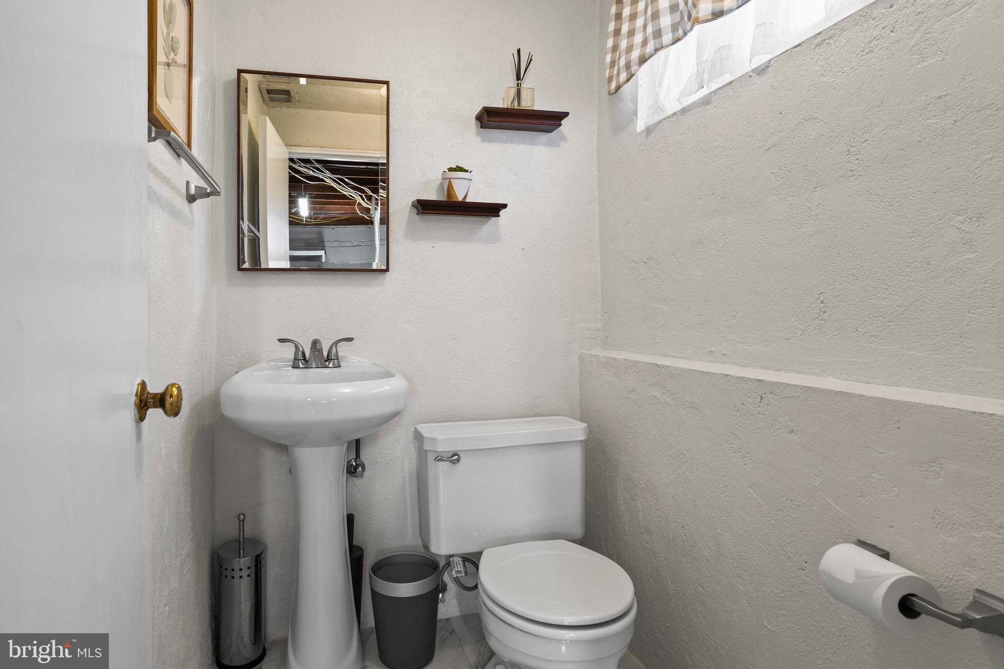 105 Longview Drive Springfield, PA 19064 - Photo 24 of 33 a bathroom with a toilet sink and mirror