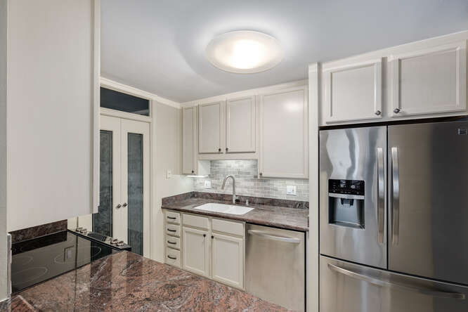 111 East Chestnut Street, Unit 22H Chicago, IL 60611 - Photo 14 of 27 a kitchen with a refrigerator and a sink