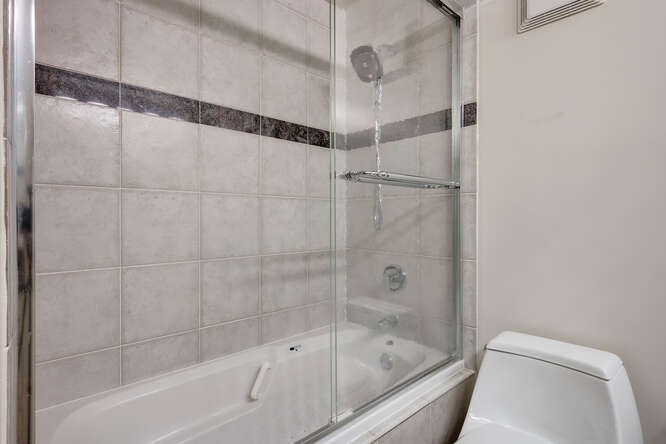 111 East Chestnut Street, Unit 22H Chicago, IL 60611 - Photo 17 of 27 a bathroom with a bathtub and a shower