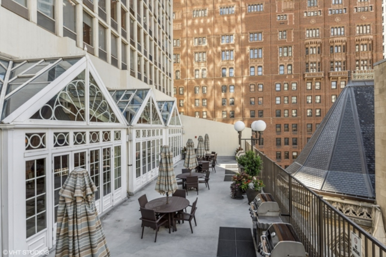 111 East Chestnut Street, Unit 22H Chicago, IL 60611 - Photo 23 of 27 a view of a balcony with chairs and potted plants