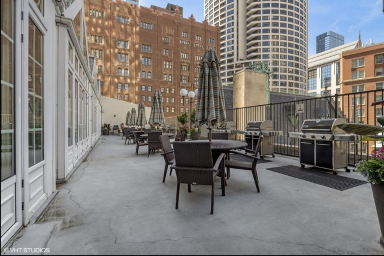 111 East Chestnut Street, Unit 22H Chicago, IL 60611 - Photo 24 of 27 a couple of chairs sitting in front of building