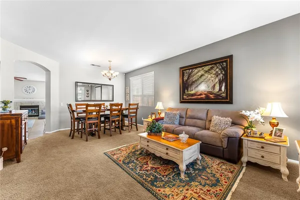 a living room with furniture and a dining table