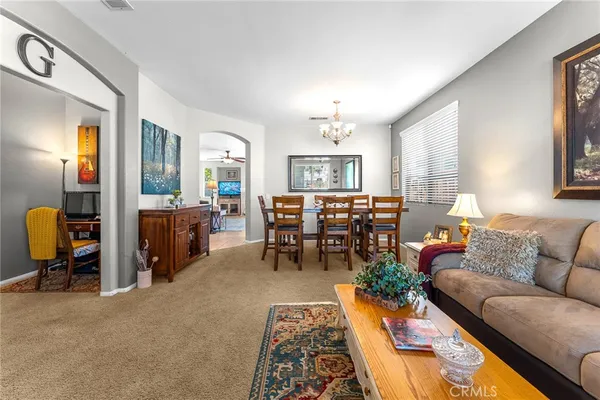 a living room with furniture and a dining table