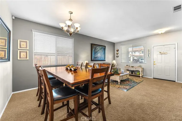 a view of a dining room with furniture and chandelier