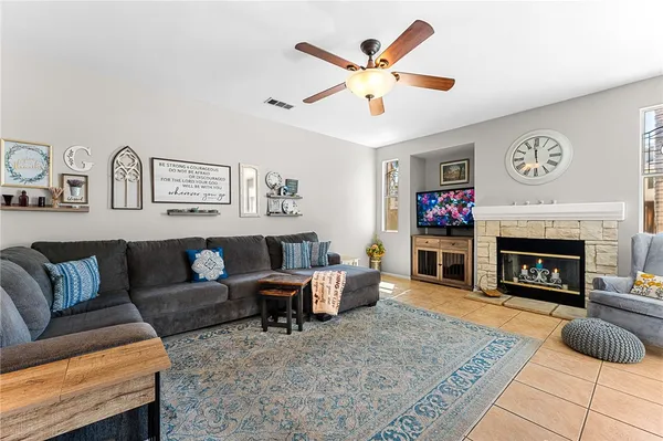 a living room with furniture and a fireplace