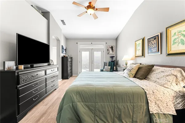 a bedroom with a bed and a flat screen tv
