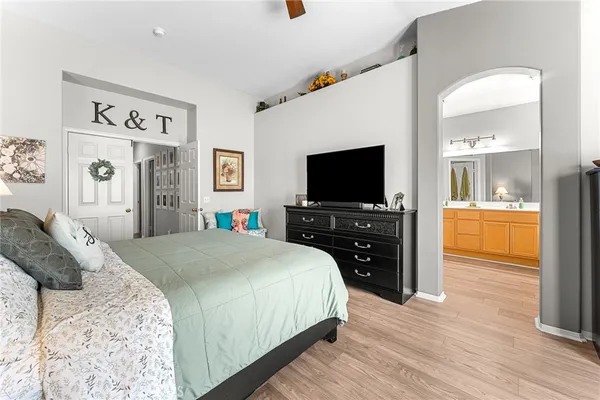 a bedroom with a bed and a flat screen tv