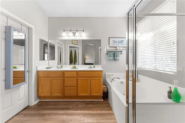a spacious bathroom with a double vanity sink and a mirror