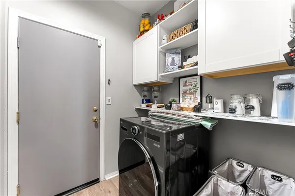 a utility room with stainless steel appliances granite countertop a sink stove and cabinets