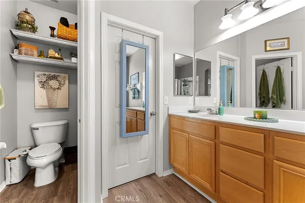a spacious bathroom with a toilet a sink and a large mirror