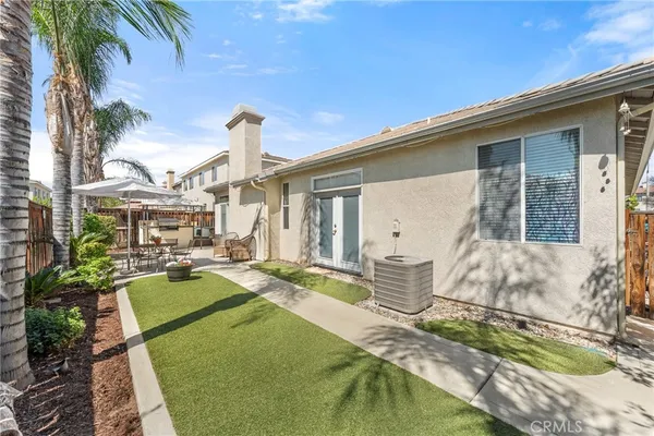a view of a house with backyard water and sitting area