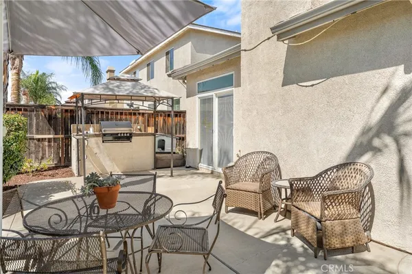 a balcony with table and chairs