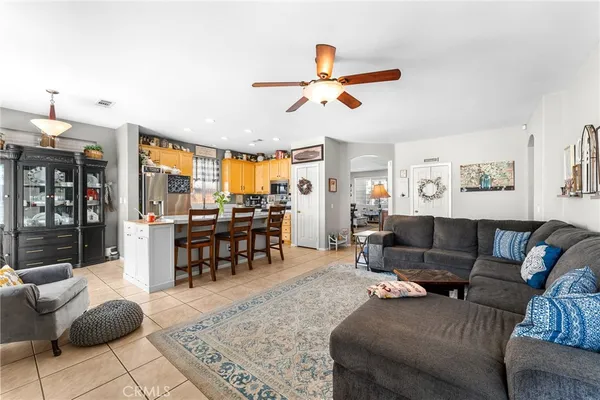a living room with furniture and a view of kitchen