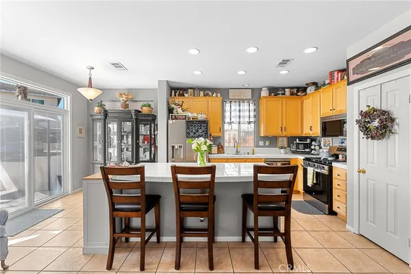 a dining room with stainless steel appliances a dining table and chairs
