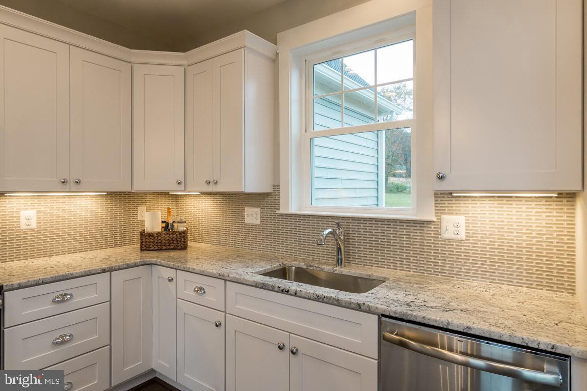 3100 Thurston Road Frederick, MD 21704 - Photo 11 of 35 a kitchen with granite countertop white cabinets and window