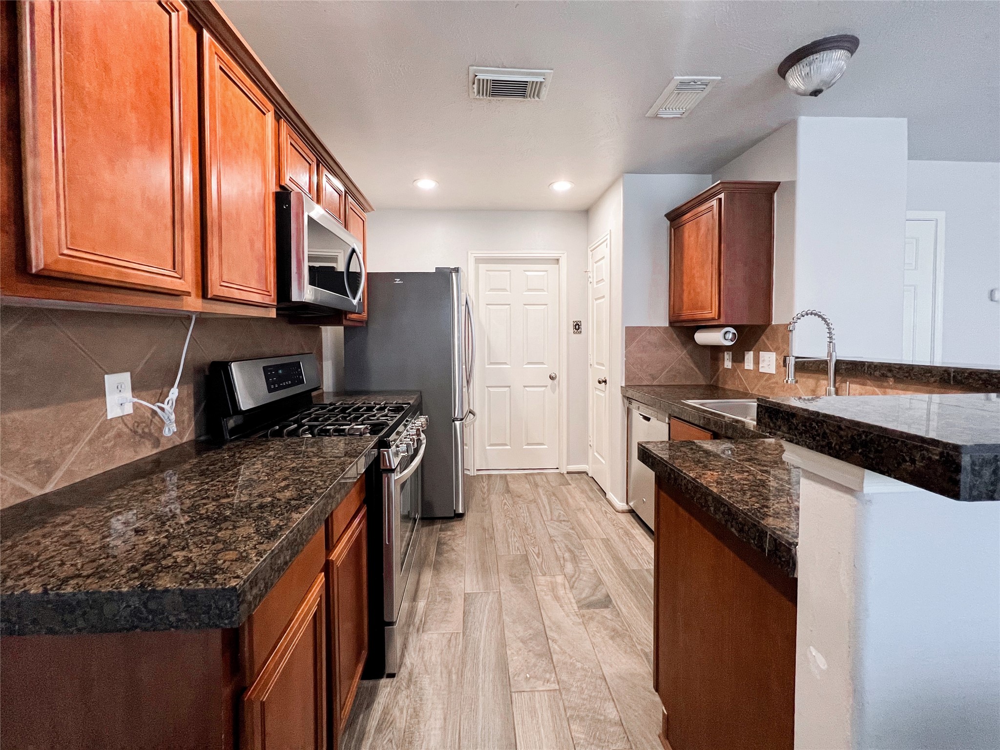 10838 Waterfern Court Houston, TX 77064 - Photo 14 of 28 Seamless indoor living with an open layout that enhances natural light and creates a bright, airy atmosphere throughout the home.