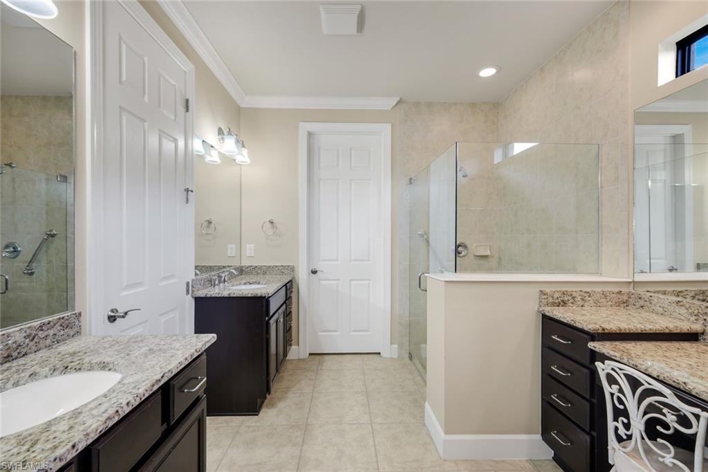 10820 Rutherford Road Fort Myers, FL 33913 - Photo 24 of 42 Dual vanity sinks, separate walk-in shower with glass enclosure, granite countertops, recessed lighting, and tile flooring