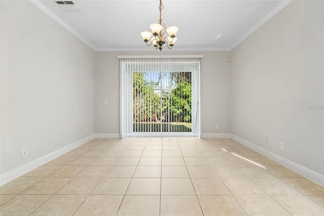 a view of a room that has wooden floor and window