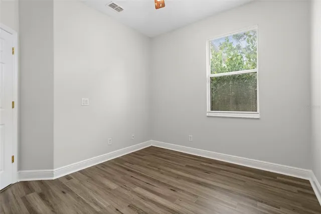 an empty room with wooden floor