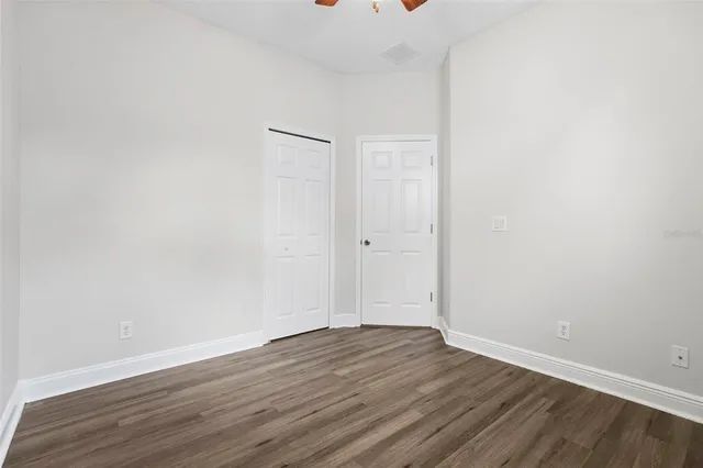 a view of a room with wooden floor and a window