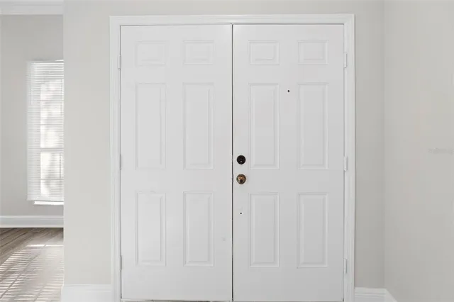 a view of an empty room and wooden floor