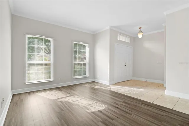 a view of an empty room with wooden floor