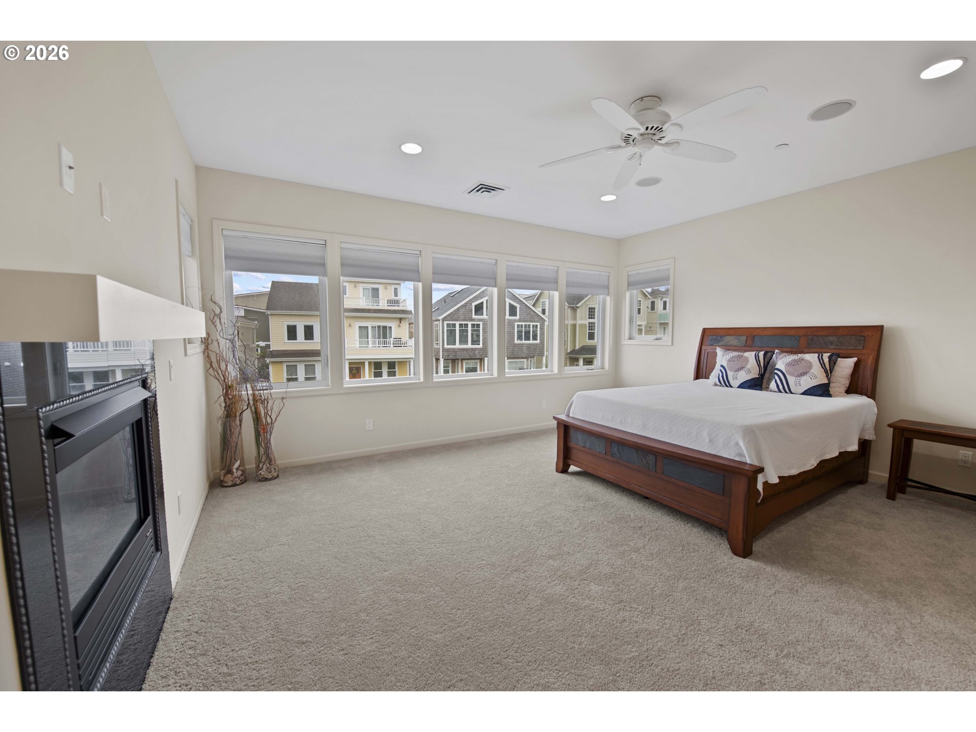 230 Round House Road Astoria, OR 97103 - Photo 26 of 43 a spacious bedroom with a bed and a large window