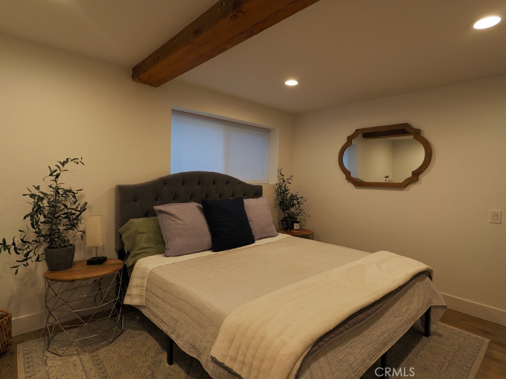 28596 North Bay Road Lake Arrowhead, CA 92352 - Photo 47 of 69 a bedroom with a bed and a chandelier