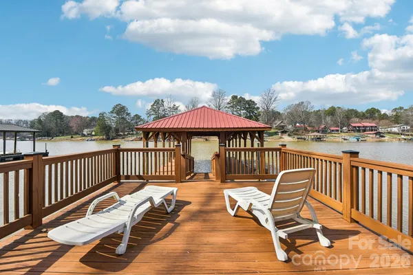 a view of a roof deck with chair and wooden floor