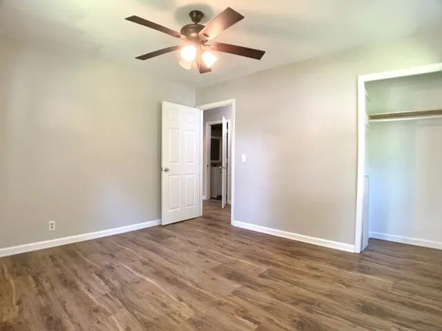 a view of an empty room with wooden floor