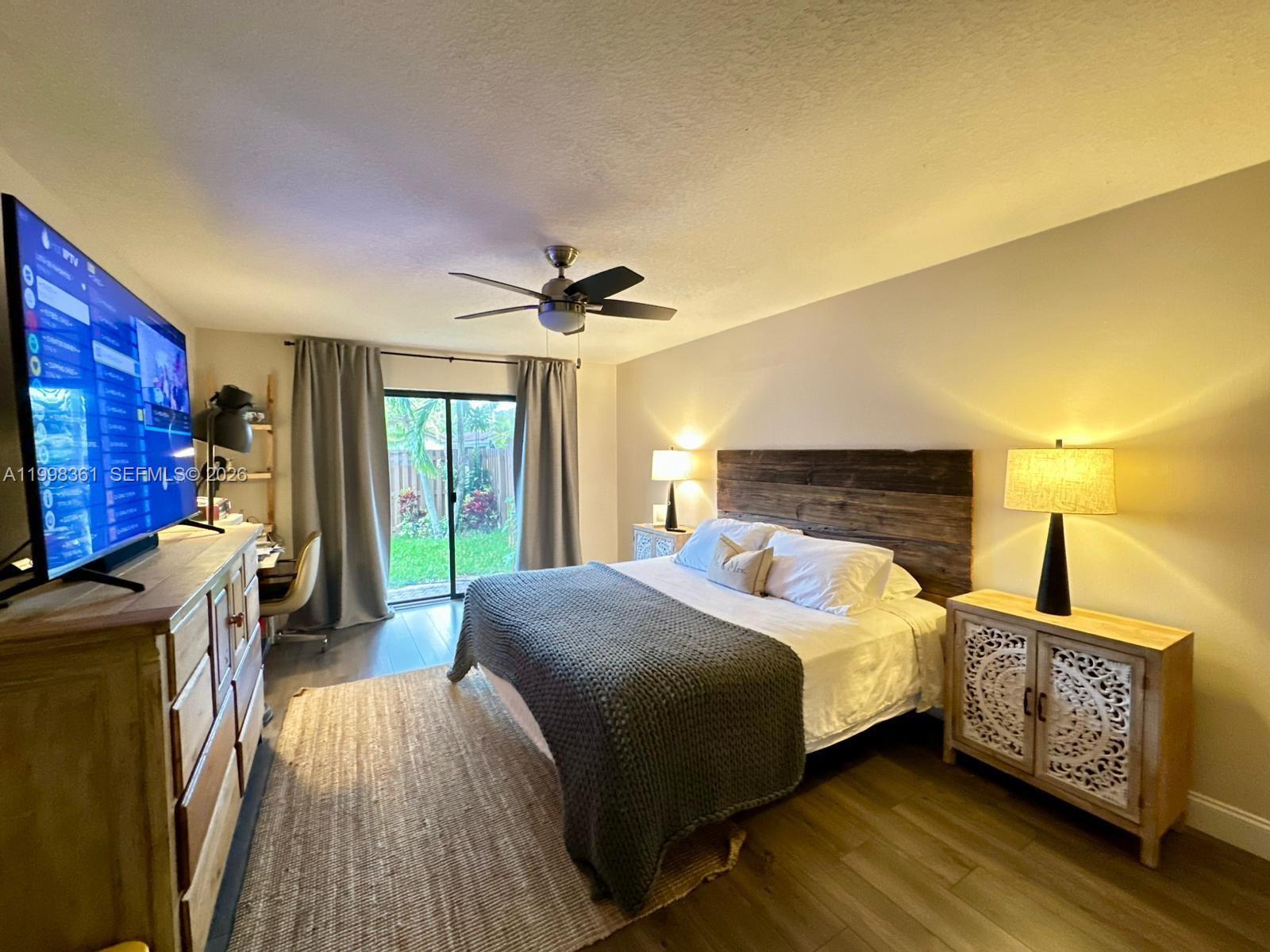 2089 Augusta Weston, FL 33326 - Photo 13 of 30 a bedroom with a bed and a dresser next to a window