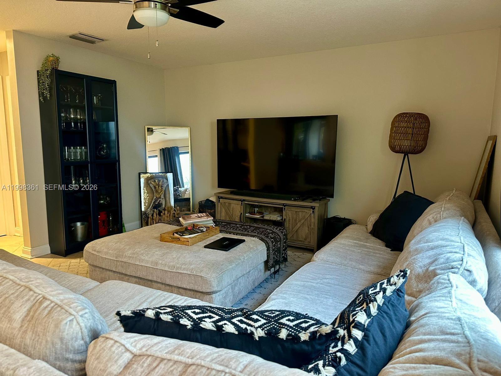 2089 Augusta Weston, FL 33326 - Photo 16 of 30 a living room with furniture and a flat screen tv