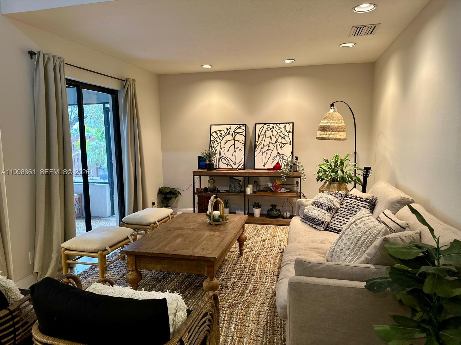 2089 Augusta Weston, FL 33326 - Photo 17 of 30 a living room with furniture and a mirror