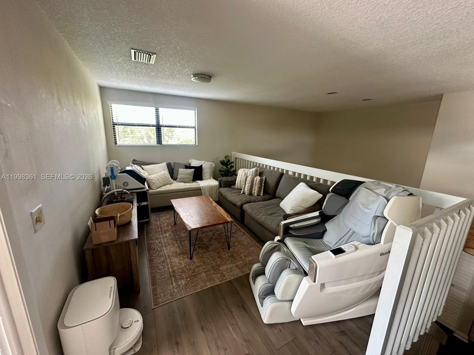 2089 Augusta Weston, FL 33326 - Photo 18 of 30 a living room with furniture and a mirror