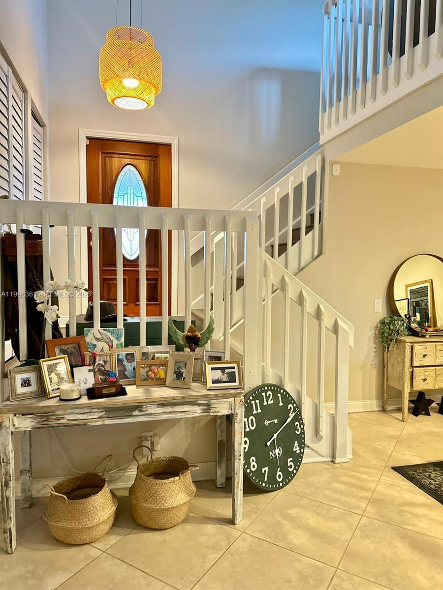 2089 Augusta Weston, FL 33326 - Photo 20 of 30 a living room with fireplace furniture and a chandelier