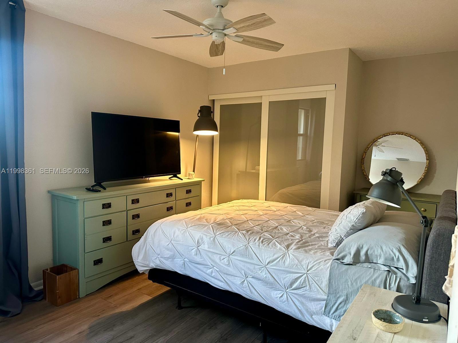 2089 Augusta Weston, FL 33326 - Photo 28 of 30 a bedroom with a bed and a flat tv screen on dresser