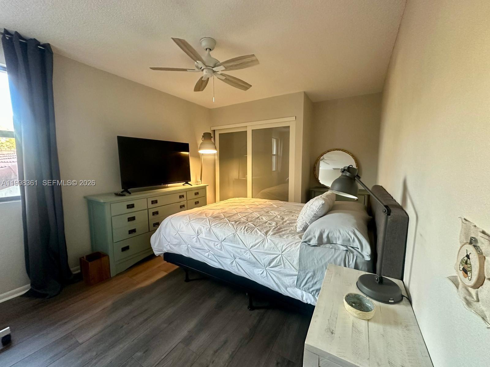 2089 Augusta Weston, FL 33326 - Photo 29 of 30 a bedroom with a bed and a flat tv screen on dresser