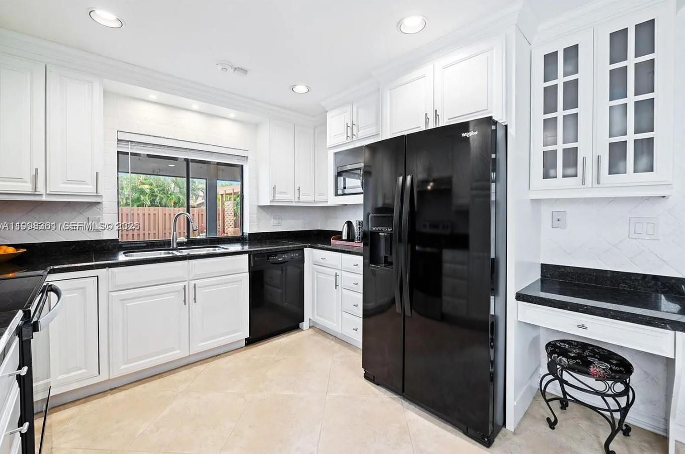 2089 Augusta Weston, FL 33326 - Photo 8 of 30 a kitchen with a refrigerator and a sink