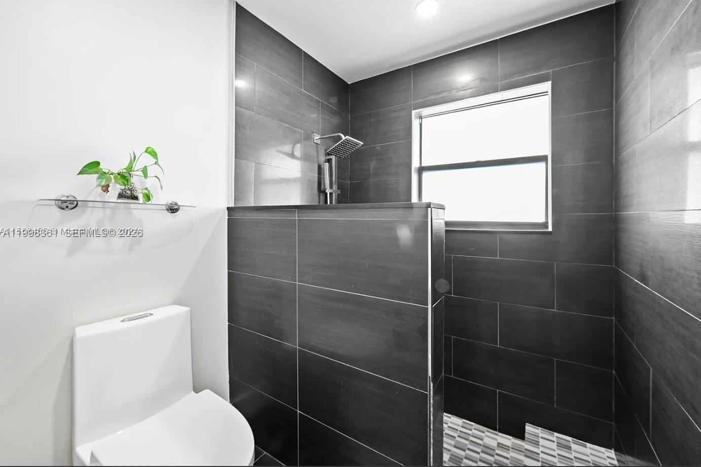 2089 Augusta Weston, FL 33326 - Photo 9 of 30 a bathroom with a toilet sink and shower