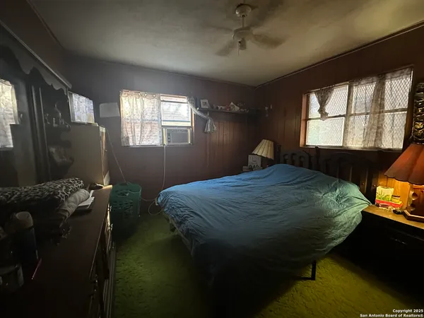 a bed sitting in a bedroom next to a window